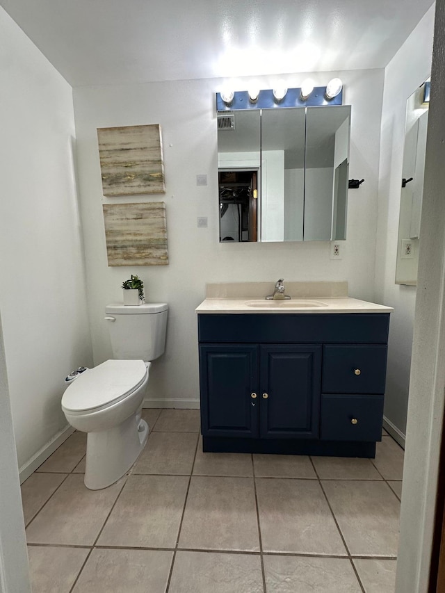 bathroom with tile patterned floors, vanity, and toilet