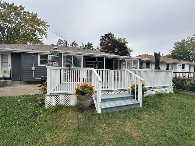 rear view of property with a yard