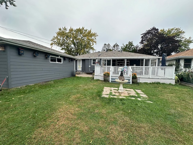 back of house with a yard and a deck