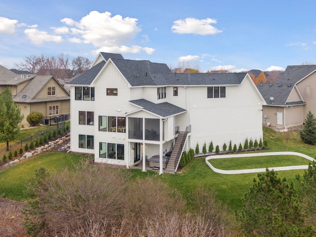 back of property featuring a sunroom and a yard