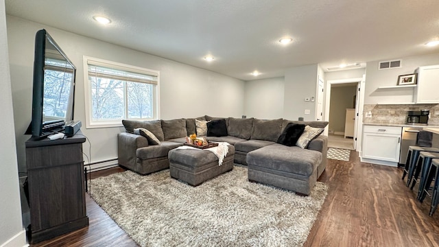 living room with dark hardwood / wood-style floors and baseboard heating