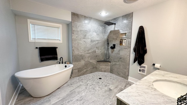 bathroom with vanity, shower with separate bathtub, and a textured ceiling