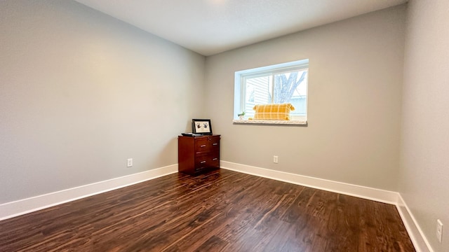 unfurnished room featuring dark hardwood / wood-style flooring