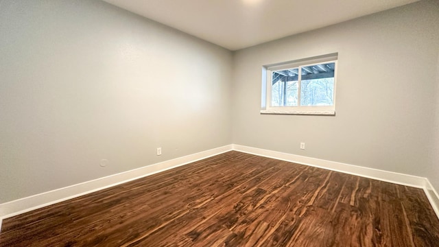 empty room featuring dark wood-type flooring