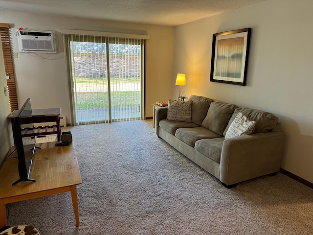 carpeted living room featuring a wall mounted AC and a textured ceiling