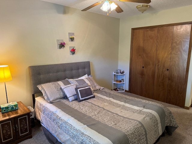 carpeted bedroom with a textured ceiling and ceiling fan