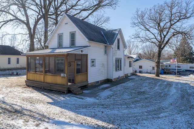 view of front of property with a sunroom