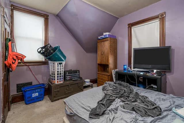 carpeted bedroom featuring lofted ceiling