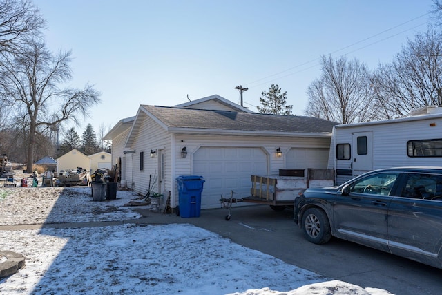 view of snowy exterior with a garage
