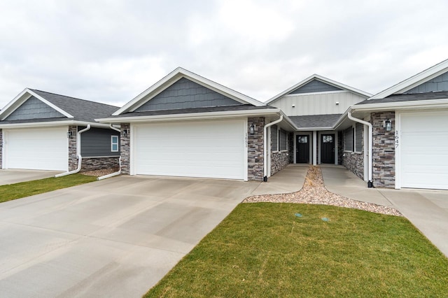 ranch-style home featuring board and batten siding, stone siding, driveway, and a garage