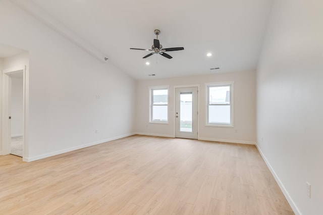 spare room with ceiling fan, light wood-type flooring, visible vents, and baseboards