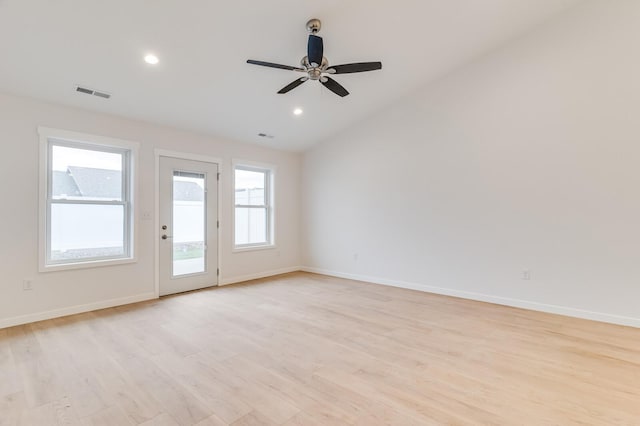 empty room with light wood finished floors, recessed lighting, visible vents, vaulted ceiling, and baseboards