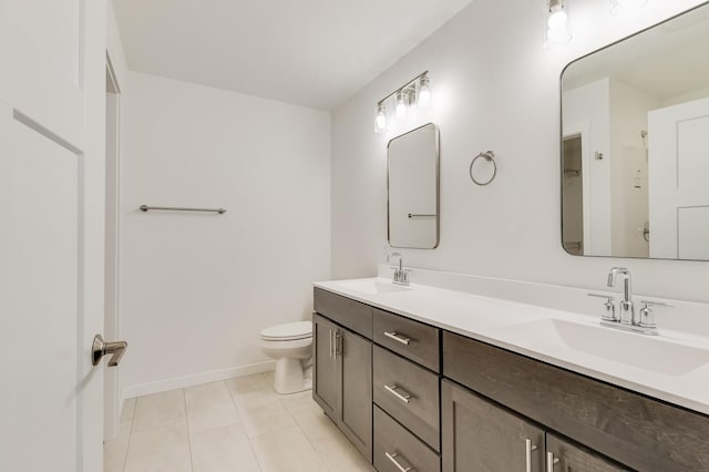 full bathroom with double vanity, a sink, toilet, and tile patterned floors