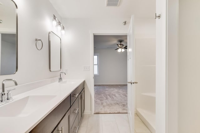 bathroom featuring tile patterned flooring, visible vents, a sink, and double vanity