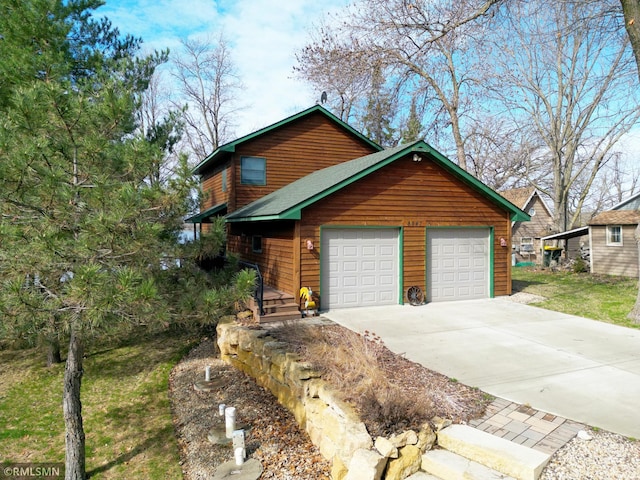 view of front of home featuring concrete driveway and a garage