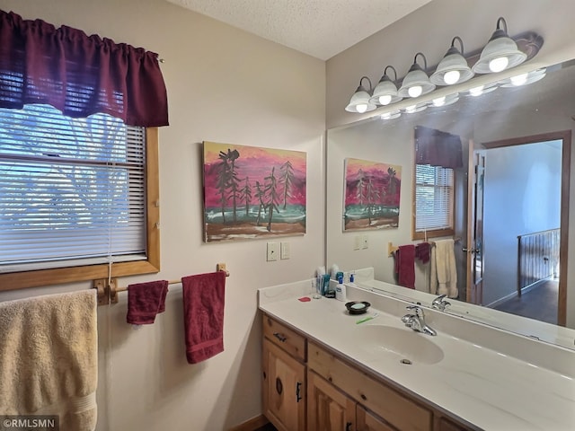 bathroom featuring a textured ceiling and vanity