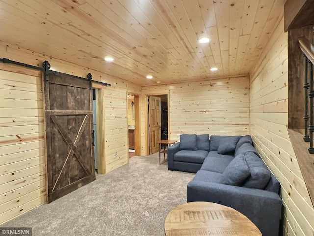 carpeted living area featuring wood walls, a barn door, recessed lighting, and wood ceiling