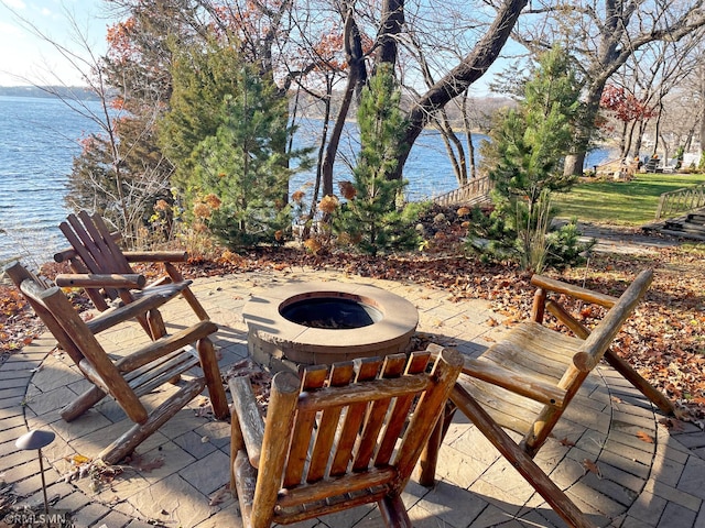 view of patio / terrace featuring a fire pit and a water view