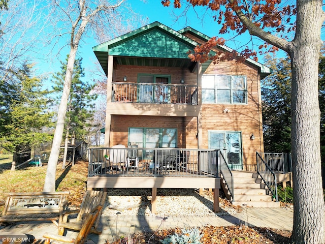 rear view of house featuring a balcony