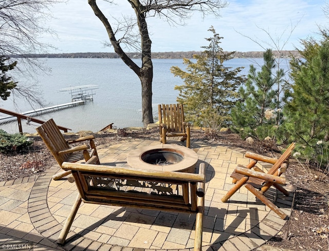 view of patio / terrace with a water view and a fire pit