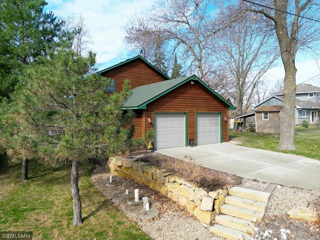 view of property exterior featuring a lawn, concrete driveway, and roof with shingles