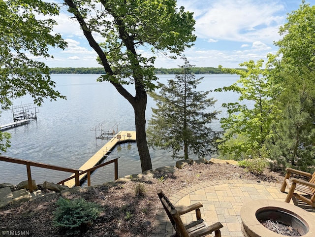 8947 Ingram Ave NW, Annandale, MN 55302 - dock featuring a fire pit, a water view, and a patio