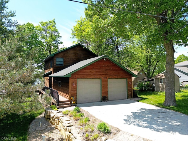 8947 Ingram Ave NW, Annandale, MN 55302 - chalet / cabin featuring concrete driveway