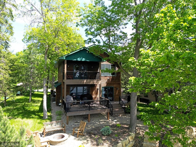 8947 Ingram Ave NW, Annandale, MN 55302 - rear view of property featuring an outdoor fire pit, a deck, stairway, a patio, and a yard