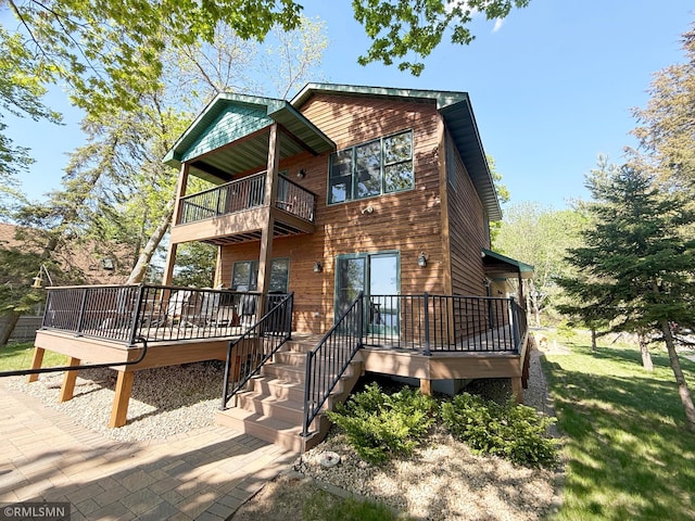 8947 Ingram Ave NW, Annandale, MN 55302 - rustic home featuring a balcony, a deck, and a front lawn