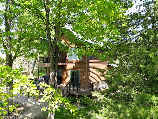 8947 Ingram Ave NW, Annandale, MN 55302 - view of side of home featuring a deck and a balcony