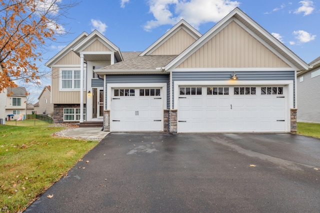 craftsman-style house featuring a front yard and a garage