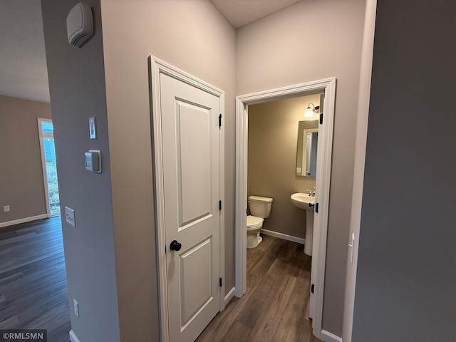 hallway with dark hardwood / wood-style flooring