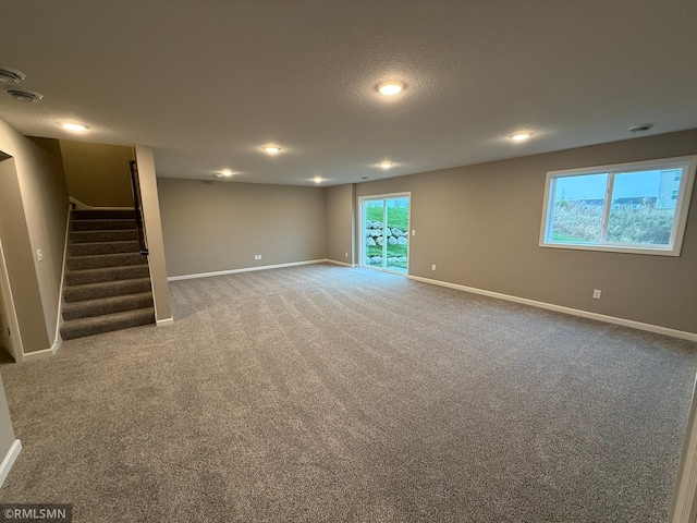 interior space featuring carpet floors and a textured ceiling