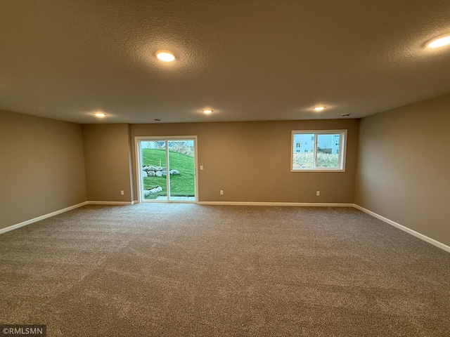 unfurnished room with carpet floors and a textured ceiling