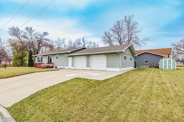 ranch-style home featuring a garage, a front lawn, a storage shed, and a wooden deck