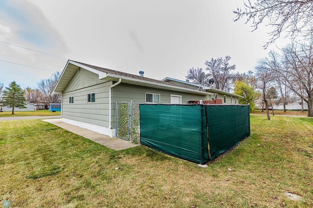 view of side of property with a lawn