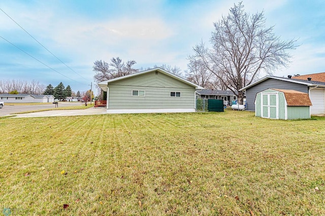 view of side of home with a lawn and a storage unit