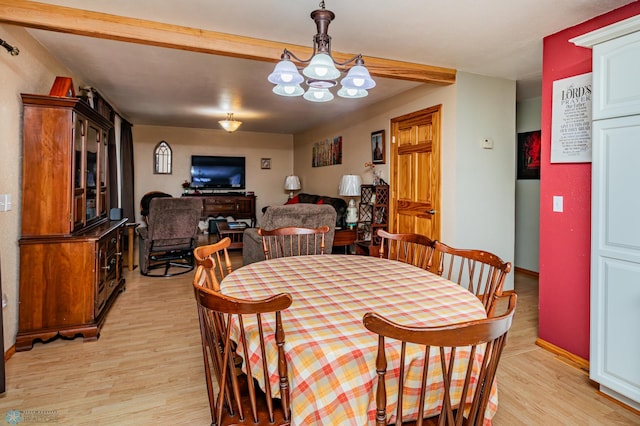 dining room featuring a chandelier and light wood-type flooring