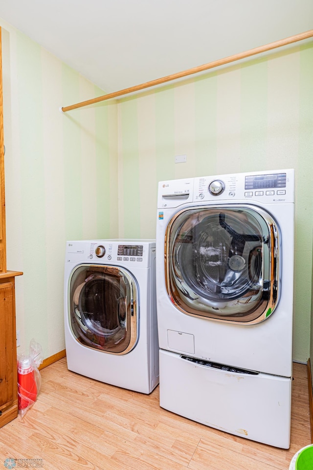 washroom featuring light wood-type flooring and washing machine and clothes dryer