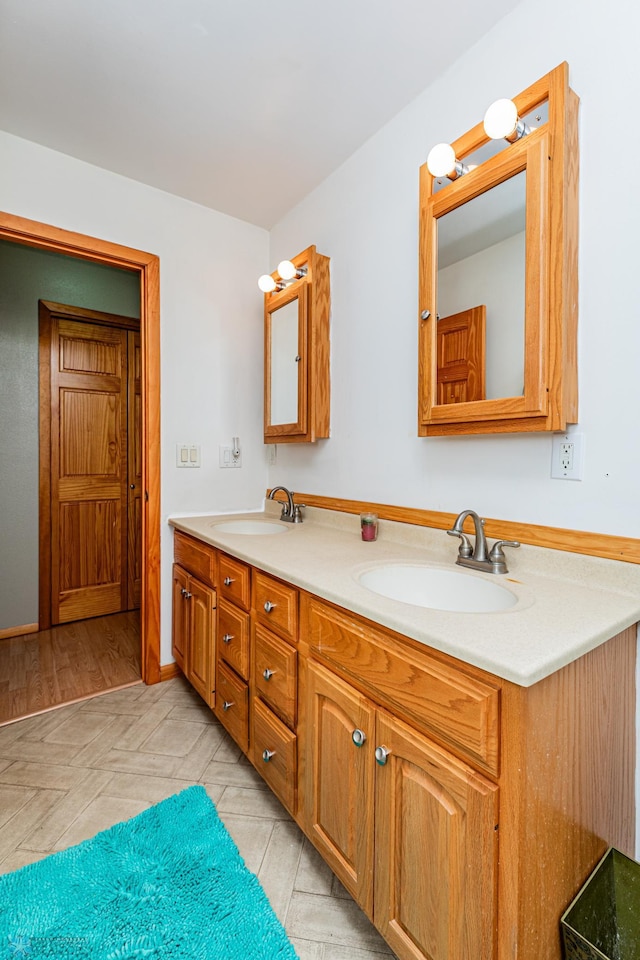 bathroom with hardwood / wood-style floors and vanity