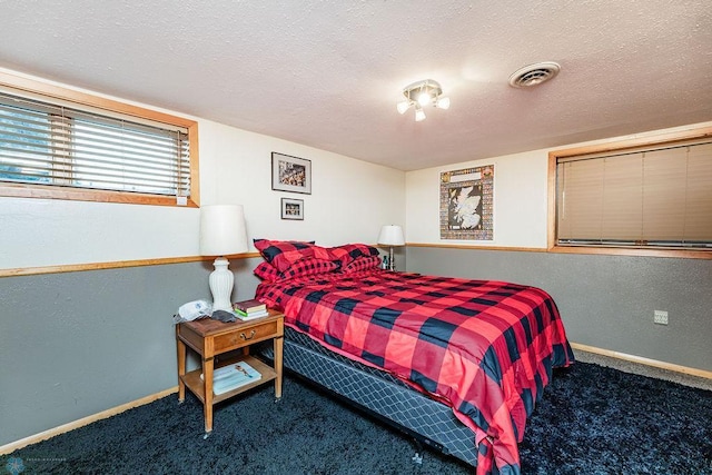 carpeted bedroom with a textured ceiling