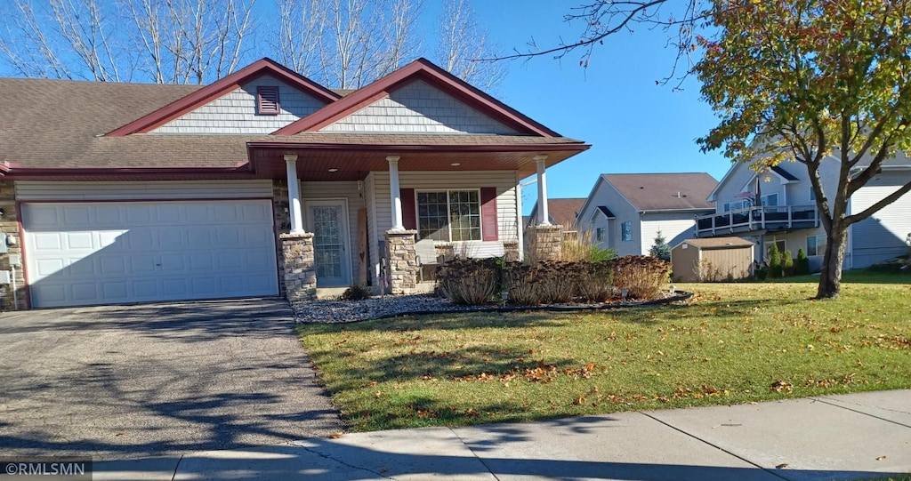 view of front of home with a front yard and a garage