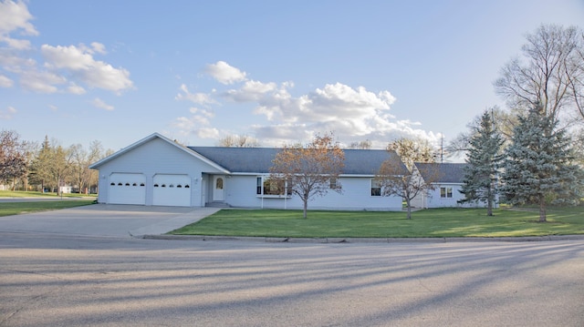 ranch-style home featuring a garage and a front lawn