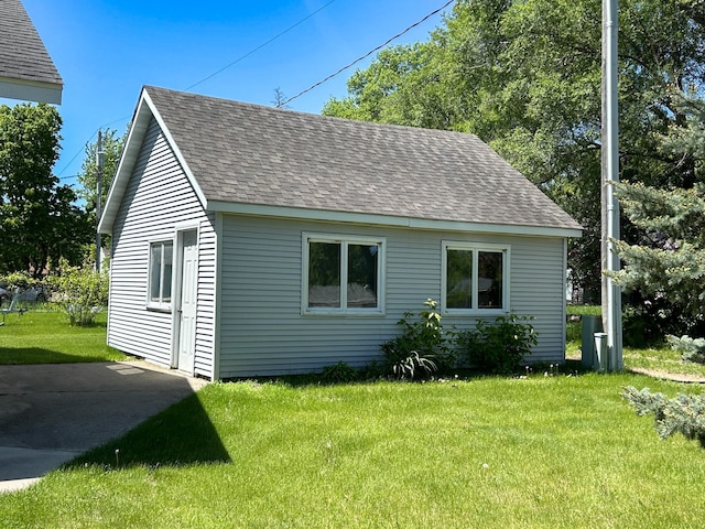 view of side of home with a yard