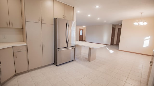 kitchen with hanging light fixtures, a notable chandelier, stainless steel fridge, and cream cabinetry