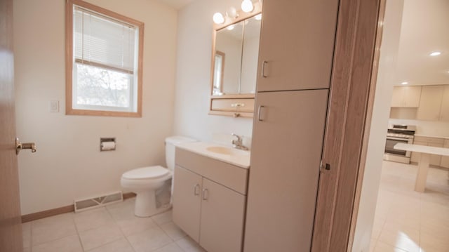 bathroom featuring tile patterned floors, vanity, and toilet