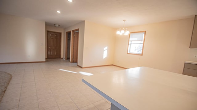 unfurnished dining area featuring light tile patterned floors and an inviting chandelier