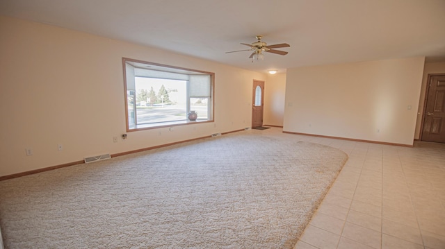 empty room with light tile patterned floors and ceiling fan