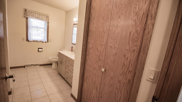 bathroom featuring vanity, toilet, and tile patterned flooring