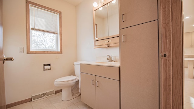 bathroom featuring vanity, tile patterned flooring, and toilet